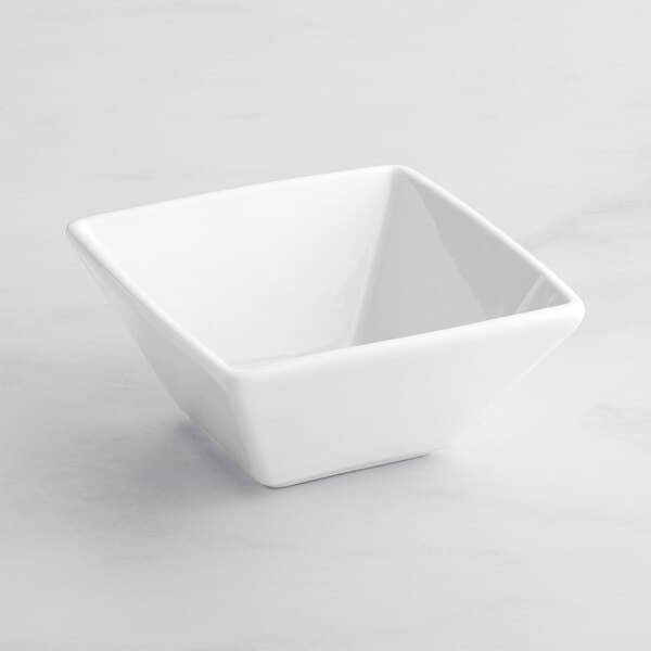 An Acopa bright white square bowl on a white surface.