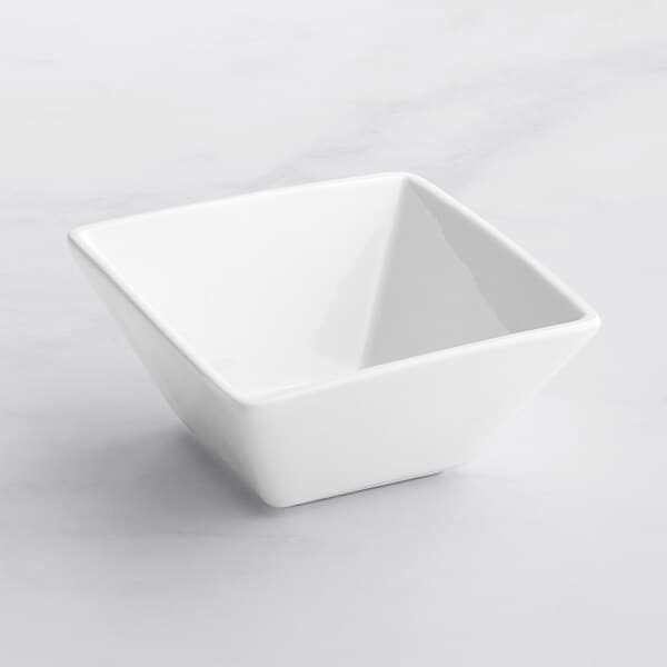 An Acopa bright white square bowl on a white surface.