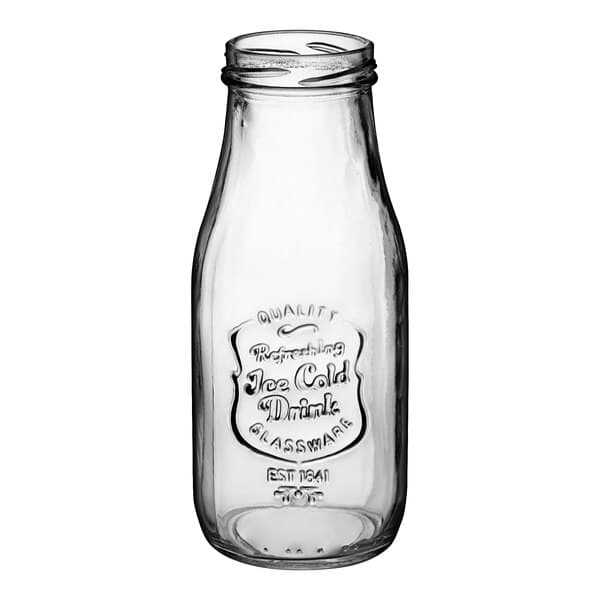 An Acopa glass milk bottle with a lid.