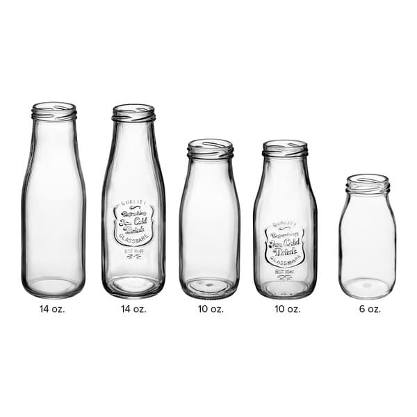 An Acopa clear glass milk bottle with an embossed label and black lid.