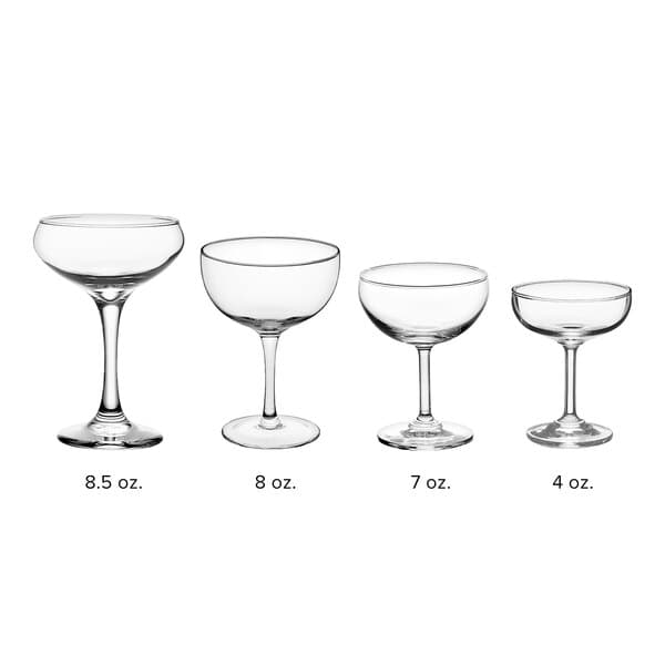 A row of clear Acopa Coupe wine glasses with stems.
