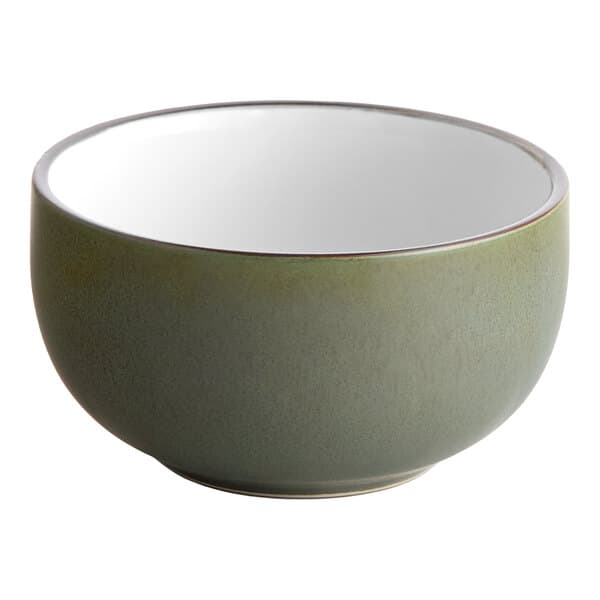A moss green stoneware bowl with a white rim.