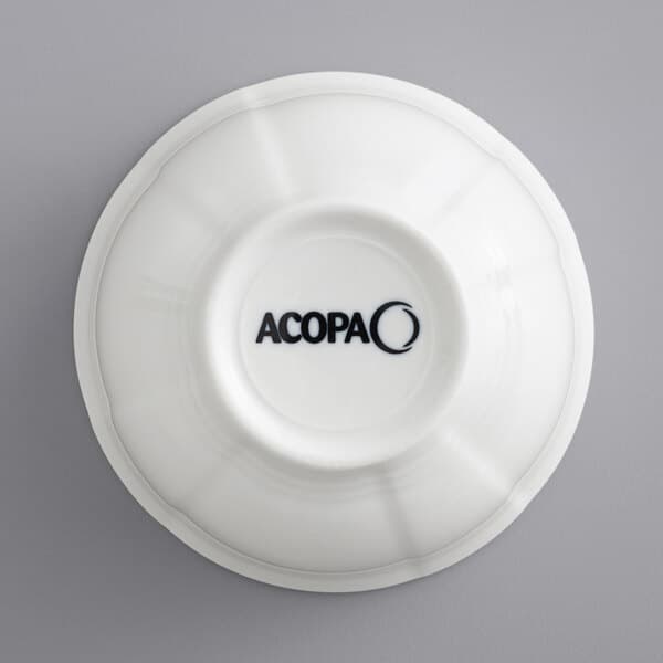 A white Acopa porcelain bouillon cup with scalloped edges.