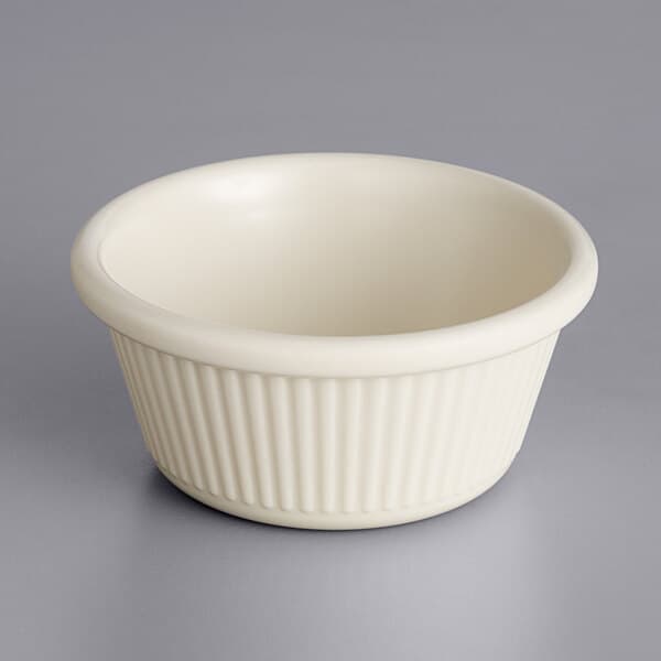 A white Acopa fluted ramekin on a gray surface.