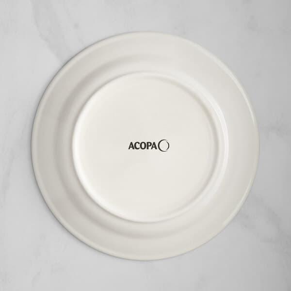 An Acopa ivory stoneware plate with blue bands and black text on the rim.