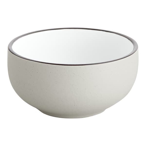 A white stoneware bowl with a brown rim.