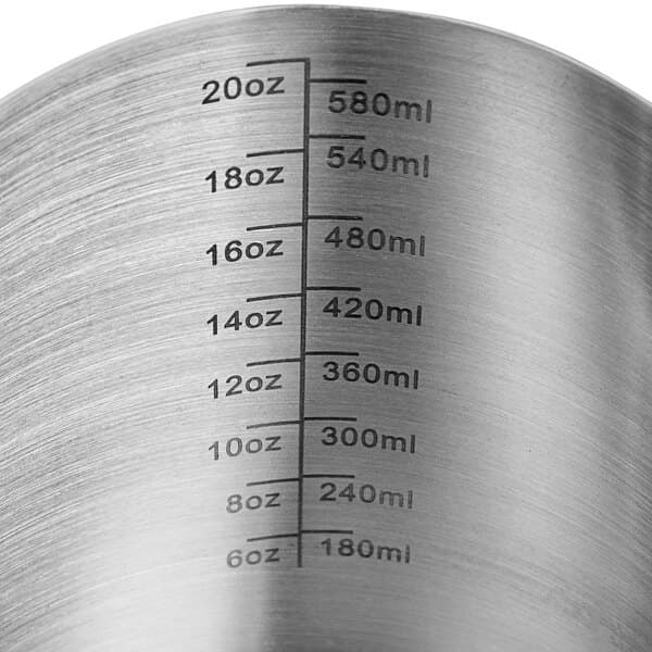 An Acopa stainless steel frothing pitcher with measuring lines.