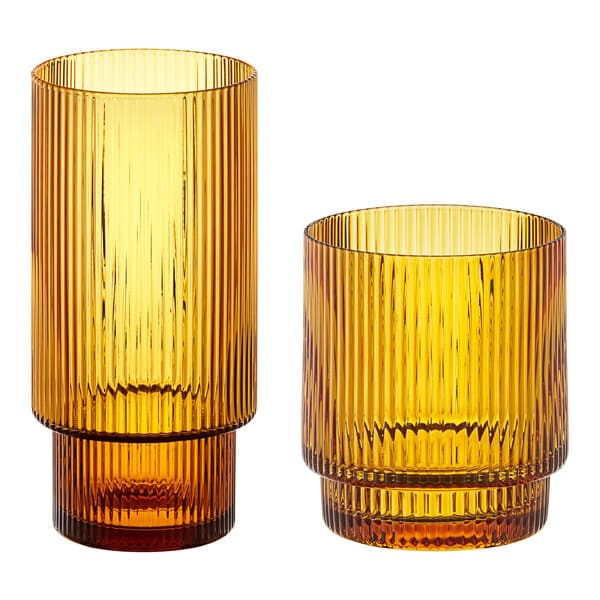 Two Acopa Lore amber glasses with a stripe pattern.
