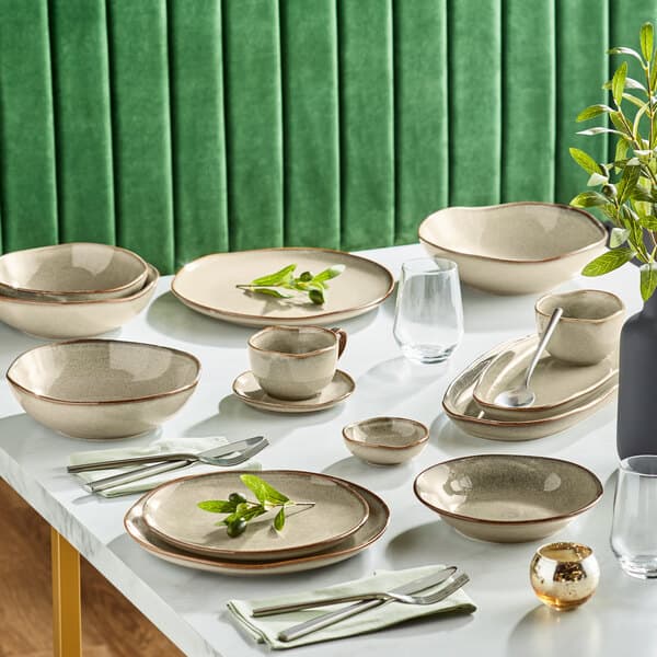 A table set with Acopa Heather Gray china sauce cups, plates, and bowls.