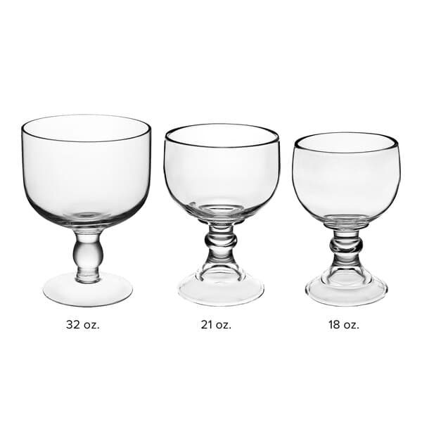 A row of clear Acopa Schooner glasses with stems and bases.